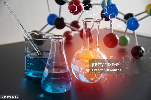 digital composite image of liquids and molecular structure on table - chemistry stock pictures, royalty-free photos & images