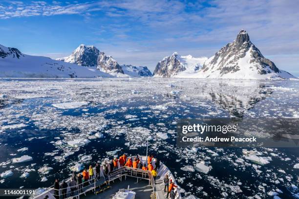 the bow of a ship heading toward the lemaire channel - antarctica people stock pictures, royalty-free photos & images