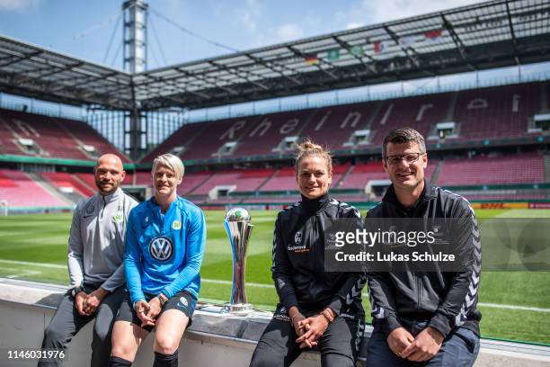 Head coach Stephan Lerch and Nilla Fischer of VfL Wolfsburg pose with the trophy and Clara Schoene and Head coach Jens Scheuer of SC Freiburg after...