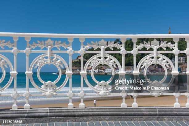 decorative wrought iron railing on the promenade, la concha beach, san sebastian, basque country, spain - railing imagens e fotografias de stock