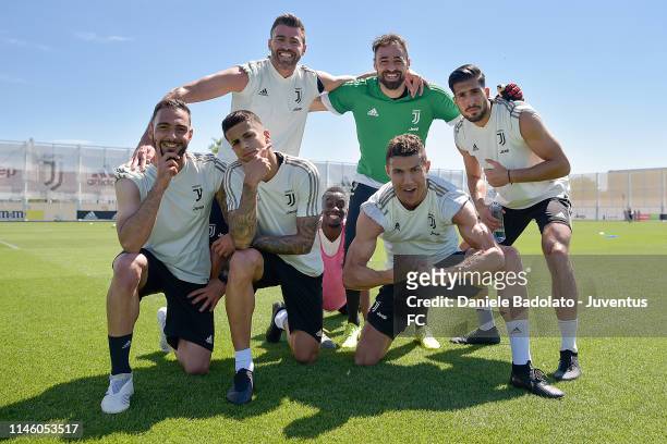Juventus players Grigoris Kastanos, Andrea Barzagli, Joao Cancelo, Blaise Matuidi, Carlo Pinsoglio, Cristiano Ronaldo and Emre Can pose during a...