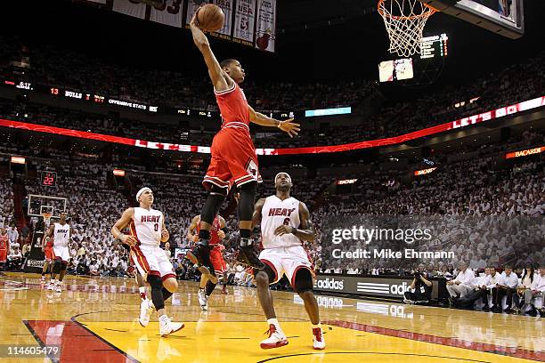 Derrick Rose of the Chicago Bulls dunks against LeBron James and Mike Bibby of the Miami Heat in Game Four of the Eastern Conference Finals during...