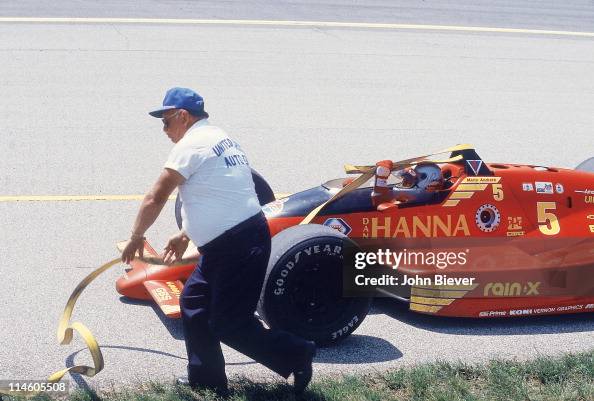 Mario Andretti getting pulled by rope after stalling during race at ...