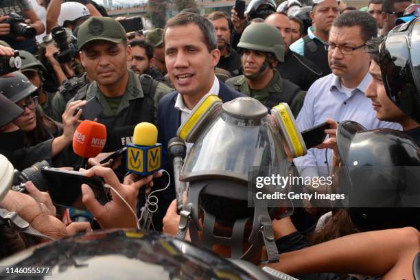 Venezuelan opposition leader Juan Guaidó, recognized by many members of the international community as the country's rightful interim ruler, talks to...