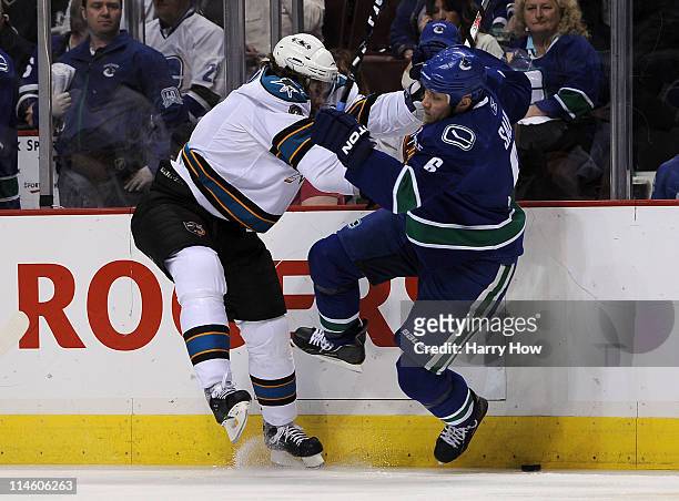 Douglas Murray of the San Jose Sharks checks Sami Salo of the Vancouver Canucks in the first period in Game Five of the Western Conference Finals...