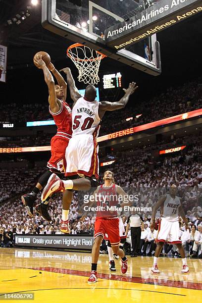 Derrick Rose of the Chicago Bulls dunks on Joel Anthony of the Miami Heat in the first half of Game Four of the Eastern Conference Finals during the...