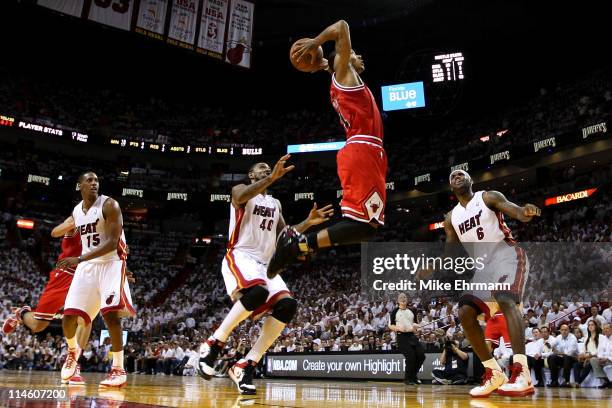 Derrick Rose of the Chicago Bulls goes up for a dunk against Mario Chalmers, Udonis Haslem and LeBron James of the Miami Heat in the first half of...