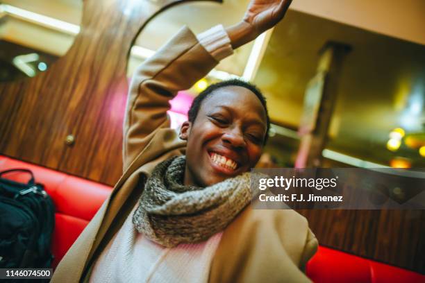 happy woman in a bar interior - bar paris photos et images de collection