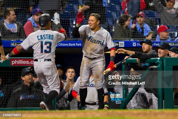 Starlin Castro of the Miami Marlins celebrates with Miguel Rojas after hitting a two run home run in the top of the tenth inning against the...