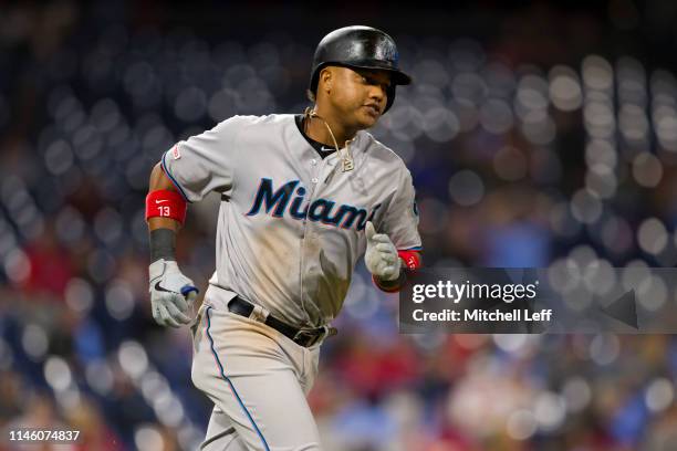 Starlin Castro of the Miami Marlins rounds the bases after hitting a two run home run in the top of the tenth inning against the Philadelphia...