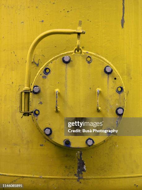 porthole of rusty industrial tank - ironclad stock pictures, royalty-free photos & images