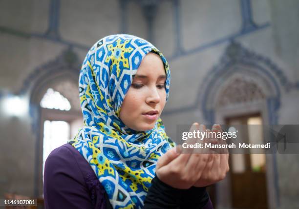 muslim girl is praying in the mosque - namaz stock pictures, royalty-free photos & images