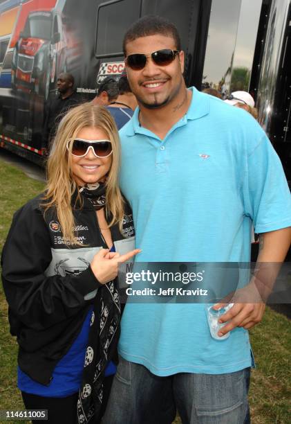 Fergie and Shawne Merriman during The 5th Annual Cadillac Super Bowl Grand Prix at American Airlines Arena in Miami Beach, Florida, United States.