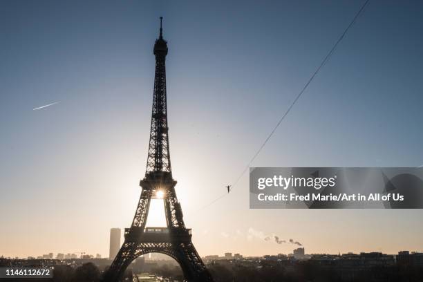 Man walk on a highline between eiffel tower and trocadero, ÎLe de france, Paris, France on December 9, 2017 in Paris, France.