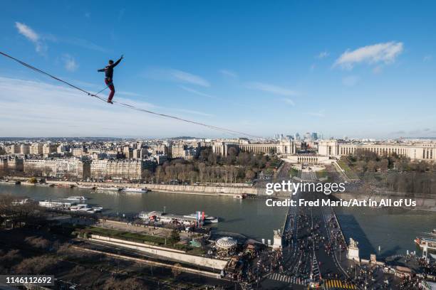 Man walk on a highline between eiffel tower and trocadero, ÎLe de france, Paris, France on December 9, 2017 in Paris, France.