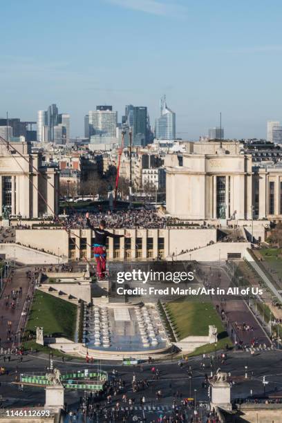 Man walk on a highline between eiffel tower and trocadero with people around, ÎLe de france, Paris, France on December 9, 2017 in Paris, France.