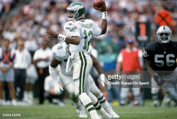 Randall Cunningham of the Philadelphia Eagles looks to pass against the Oakland Raiders during an NFL Football game September 24, 1995 at the...
