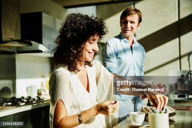 smiling wife in discussion with husband while sitting in kitchen - spanish royals host a lunch for president of mexico and his wife stockfoto's en -beelden