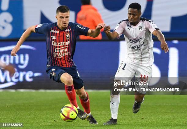 Caen's French defender Frederic Guilbert vies with Bordeaux' Guinean forward Francois Kamano during the French L1 football match between Stade...