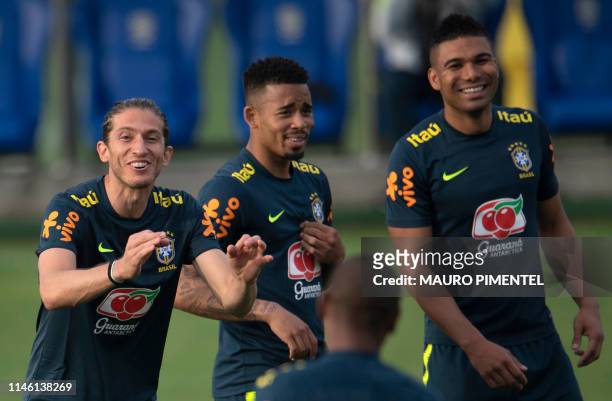 Brazilian footballers Filipe Luis, Gabriel Jesus and Casemiro laugh during a training session of the national team at Granja Comary sport complex in...