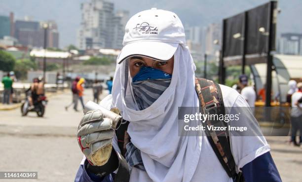 Pro-Guaidó demonstrator shows a a weapon cartridge around of Altamira distribuitor where hundred of people gathered to confront Pro-Government...