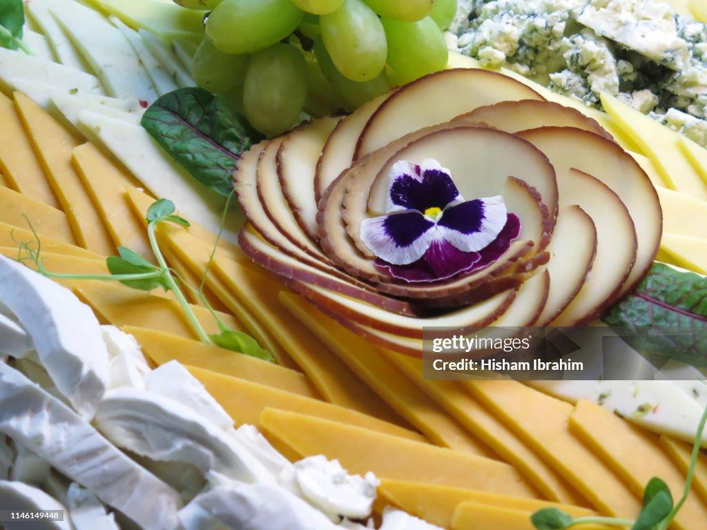 Assortment of cheese with grape.