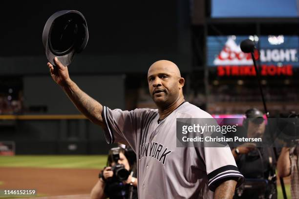 Pitcher CC Sabathia of the New York Yankees waves to the crowd after recording his 3,000th career strike out against John Ryan Murphy of the Arizona...
