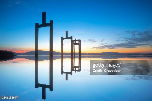 concrete pile under construction at the water in reservoir in twilight time. - pont architecture stock pictures, royalty-free photos & images