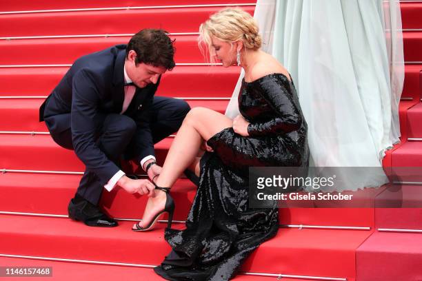Adele Exarchopoulos ties Virginie Efira shoes before the screening of "Sibyl" during the 72nd annual Cannes Film Festival on May 24, 2019 in Cannes,...
