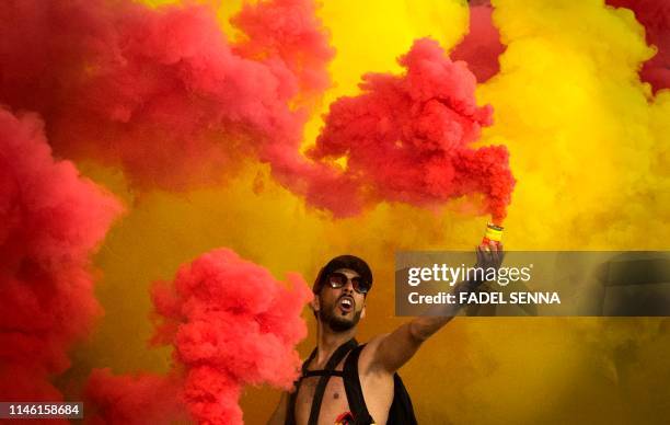 Esperance's supporter celebrates a goal during the CAF champion league final 2019 1st leg football match between Morocco's Wydad Athletic Club and...