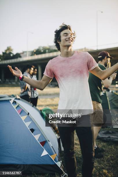 man with arms outstretched enjoying music at concert - entertainment tent stock pictures, royalty-free photos & images