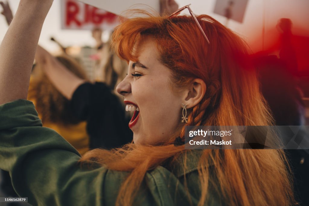 Close-up of young woman shouting while protesting for rights