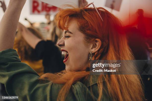 close-up of young woman shouting while protesting for rights - jämställdhet bildbanksfoton och bilder