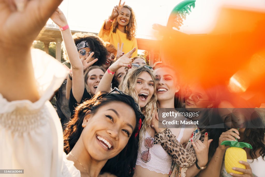 High angle view of cheerful friends enjoying in music event during summer