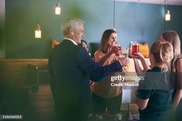 happy business colleagues celebrating success with drinks in office cafeteria during party - office party stock-fotos und bilder