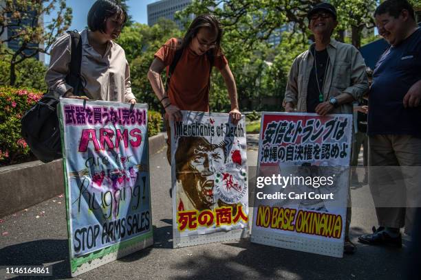 People hold placards during a demonstration against the forthcoming state visit by U.S President Donald Trump to Japan on May 25, 2019 in Tokyo,...