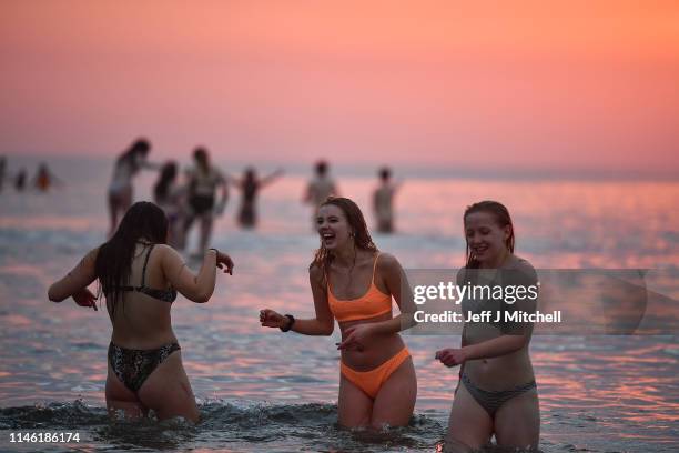 Students from St Andrews University take part in the traditional May Day dip into the North Sea at East Sands beach on May 1, 2019 in St Andrews,...