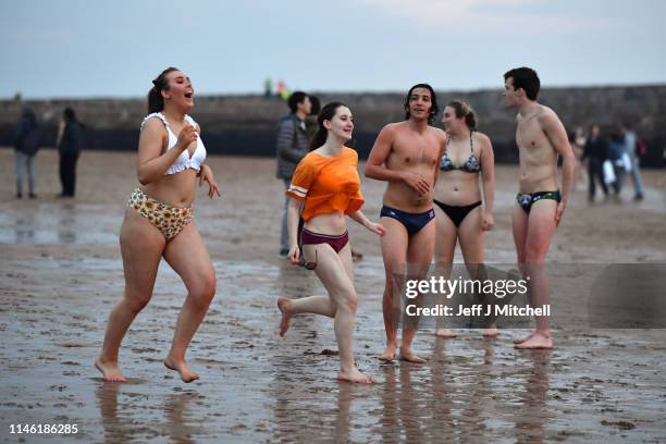 Students from St Andrews University take part in the traditional May Day dip into the North Sea at East Sands beach on May 1, 2019 in St Andrews,...