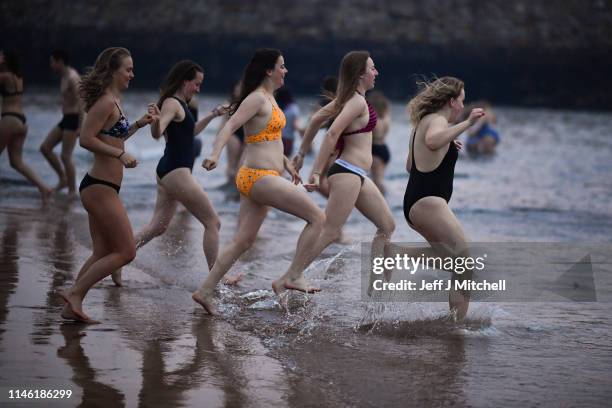 Students from St Andrews University take part in the traditional May Day dip into the North Sea at East Sands beach on May 1, 2019 in St Andrews,...