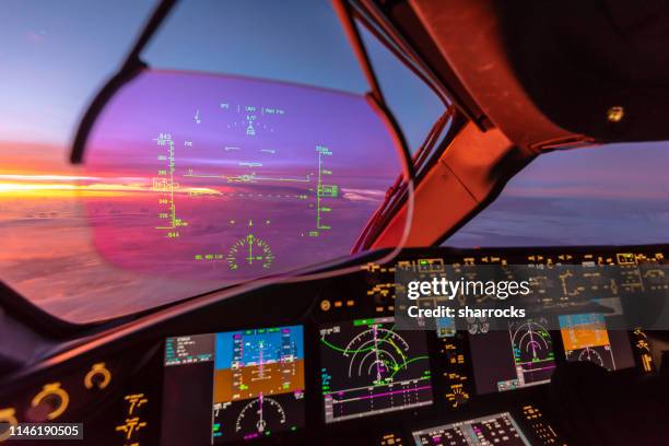 sunrise view from modern aircraft cockpit with heads up display and flight instruments - boeing 787 dreamliner stock pictures, royalty-free photos & images