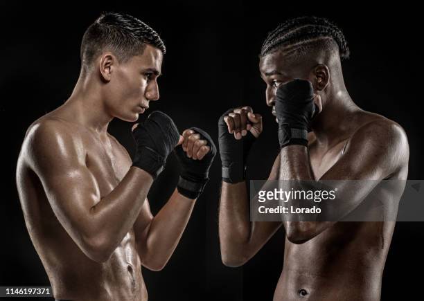 two multi-ethnic fight sport athletes facing off - mixed martial arts stock pictures, royalty-free photos & images