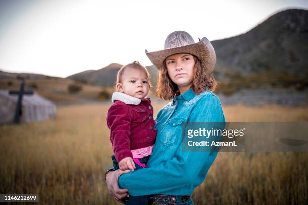 cowgirl with her little sister - western shirt stock pictures, royalty-free photos & images