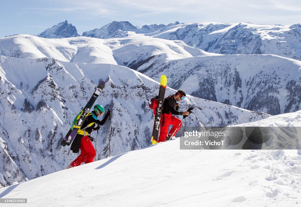 Two ski mountaineers climbing a slope in the heart of the French Alps