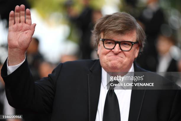Director Michael Moore waves as he arrives for the screening of the film "The Specials " at the 72nd edition of the Cannes Film Festival in Cannes,...