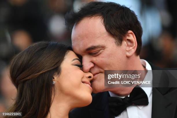 Film director Quentin Tarantino kisses his wife Israeli singer Daniella Pick as they arrive for the screening of the film "The Specials " at the 72nd...