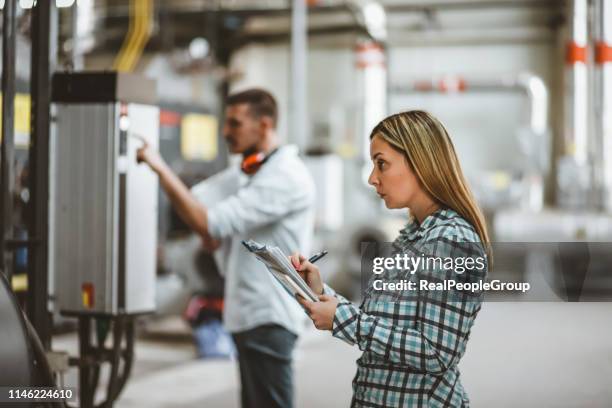 young technicians are inspecting heating system in boiler room - basement construction stock pictures, royalty-free photos & images