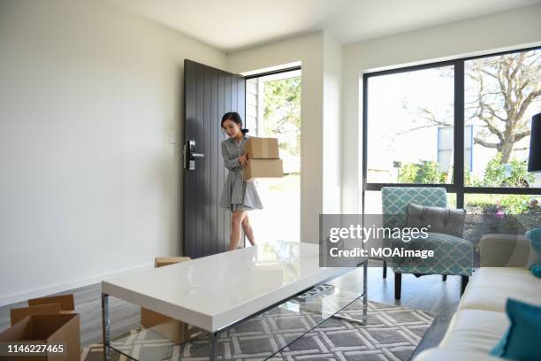 indoor life portrait of a young asian woman - house rental 個照片及圖片檔