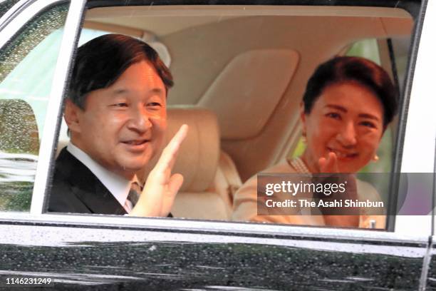 New Emperor Naruhito and Empress Masako wave to well-wishers on arrival at the Akasaka Palace after attending ceremonies on May 1, 2019 in Tokyo,...