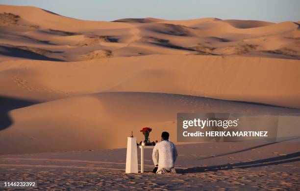 Man attends a yoga class during a meeting organized by the YSYoga System community in the Samalayuca Dune Fields in the municipality of Juarez,...