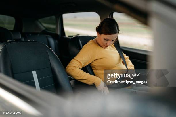 pregnant woman driving car - pregnant woman car stock pictures, royalty-free photos & images